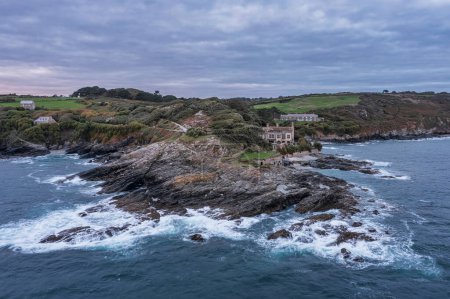 Photo for Stunning aerial drone landscape image of Prussia Cove at sunrise in Cornwall England with atmospheric moody sky and clouds - Royalty Free Image