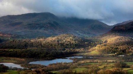 Photo for Beautiful Winter sunrise golden hour landscape view from Loughrigg Fell across the countryside in the Lake District - Royalty Free Image