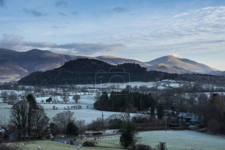 Foto de Dramatic Winter landscape image looking across countryside in Lake District with hard frost on the ground and crisp blue sky - Imagen libre de derechos