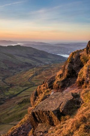 Téléchargez les photos : Beautiful Winter dawn landscape view from Red Screes in Lake District looking South towards Windermere with colorful vibrant sky - en image libre de droit
