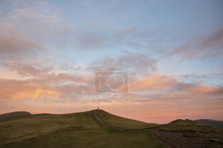 Photo for Beautiful Winter sunset landscape over Latrigg Fell in Lake District with single perosn on hilltop admiring sunset - Royalty Free Image