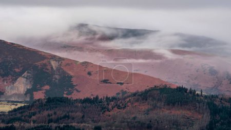 Photo for Beautiful Winter sunrise landscape image of view from Walla Crag in Lake District towards distant mountains with low cloud - Royalty Free Image