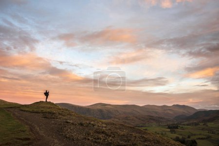 Photo for Wonderful sunset landscape image of view from Latrigg Fell towards Great Dodd and Stybarrow Dodd in Lake District with man photographing the landscape - Royalty Free Image