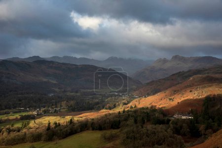 Photo for Beautiful Winter sunrise golden hour landscape view from Loughrigg Fell across the countryside towards Langdale Pikes in the Lake District - Royalty Free Image