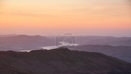 Photo for Beautiful Winter dawn landscape view from Red Screes in Lake District looking South towards Windermere with colorful vibrant sky - Royalty Free Image
