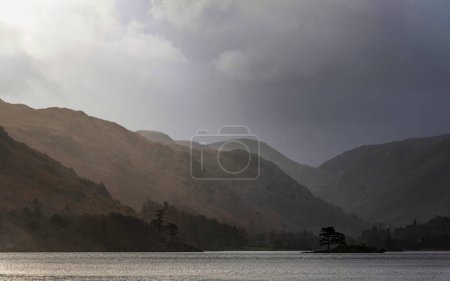 Photo for Beautiful Winter sunrise landscape over Ullwater in English Lake District with mist over lake giving a moody dramatic feel - Royalty Free Image