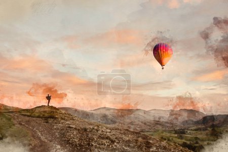 Digital watercolour painting of Wonderful sunset landscape image of view from Latrigg Fell towards Great Dodd and Stybarrow Dodd in Lake District with man photographing hot air ballon in landscape