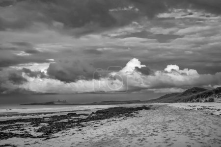 Photo for Beautiful unusual  black and white moody Winter landscape of snow on Embleton Bay beach in Northumberland England - Royalty Free Image