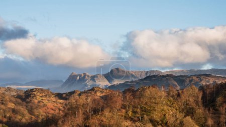 Stunning Spring landscape image in Lake District looking towards Langdale Pikes during colorful sunset