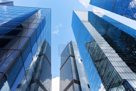 Photo for Modern glass silhouettes of skyscrapers in the city. Bottom view of modern skyscrapers in business district. - Royalty Free Image