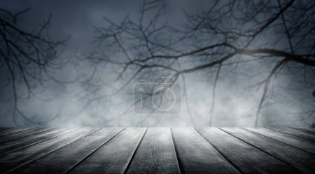 Photo for Spooky misty horror Halloween background with empty wooden planks, for product placement. Old wooden table and dead tree silhouette at night for Halloween background. - Royalty Free Image