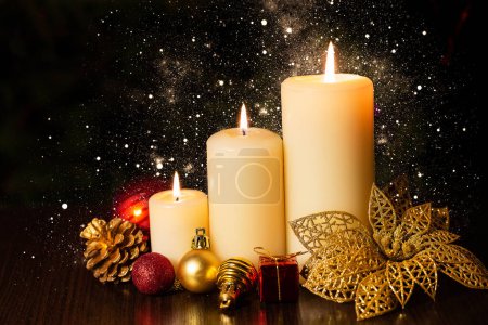 Photo for Christmas holiday card with  three burning candles and ornaments. Christmas decoration with candles over dark background with bokeh light. Christmas background. - Royalty Free Image