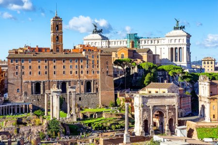 Ruins of the Roman Forum with the Capitolium and the National Monument to Victor Emmanuel II in the background in Rome, Italy.