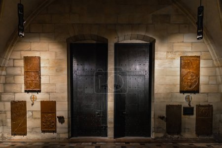 Heavy steel medieval doors in stone corridor closeup