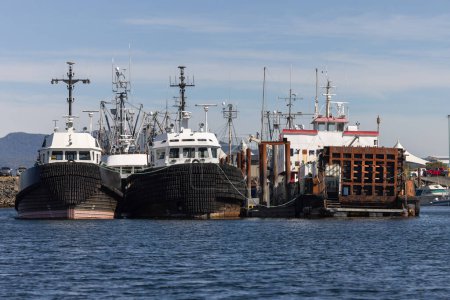 Large fishing and tugboats moored in harbor closeup