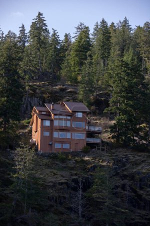 Wooden resort house perched on a forested cliff closeup