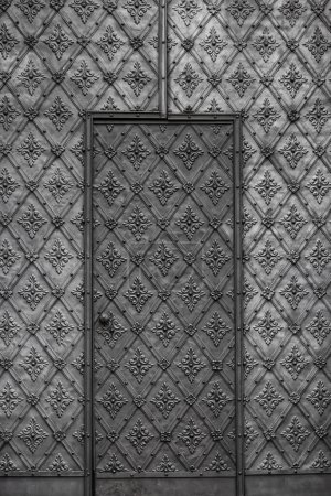 Ornate steel door with intricate metalwork designs closeup