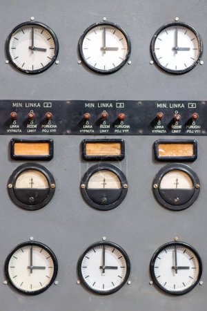 Old electric voltage clocks on radio amplifier closeup