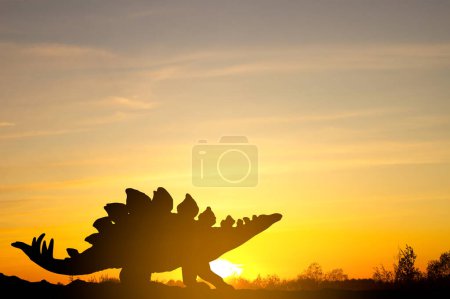 Silhouette of dinosaur against the sunset