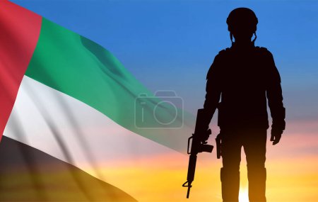 Foto de Silhouette of a soldier on background of the sunrise and UAE flag. Armed forces of United Arab Emirates. Concept for Commemoration Day, Martyrs Day, National Day. EPS10 vector - Imagen libre de derechos