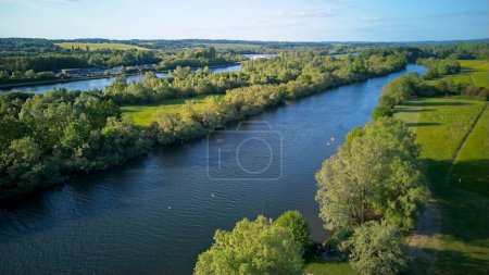 Photo for An aerial view along the Thames river by Thames Valley Park heading into Reading, United Kingdom - 03.06.2023 - Royalty Free Image