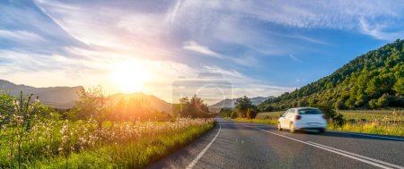 Téléchargez les photos : Voiture de location en espagne montagne paysage route au coucher du soleil - en image libre de droit