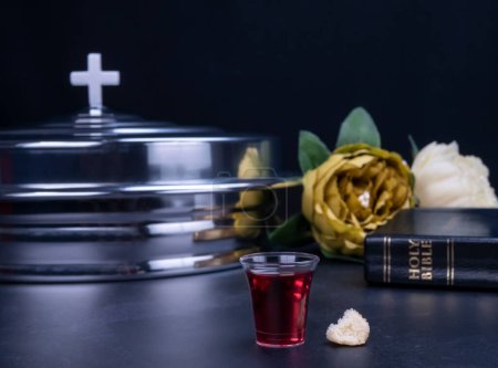 Taking communion concept - the wine and the bread symbols of Jesus Christ blood and body with Holy Bible. Easter Passover and Lord Supper concept.
