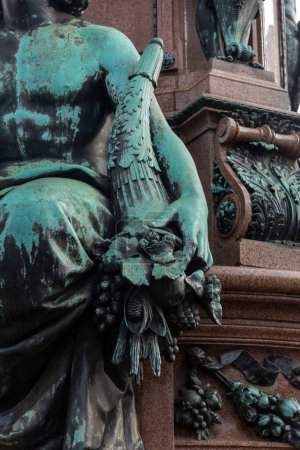 Detail from and old bronze statue in Munich, Germany