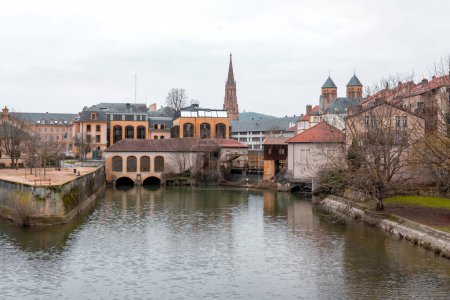 Cityscape view from the beautiful city of Metz in France. Bridges, houses and churches on the bank of the Moselle River.