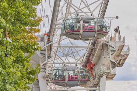 Photo for One of London s eye capsules with tourists in different hypostasis - Royalty Free Image
