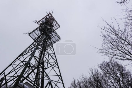 Photo for Transmission tower at a mountain with gray sky in the winter - Royalty Free Image