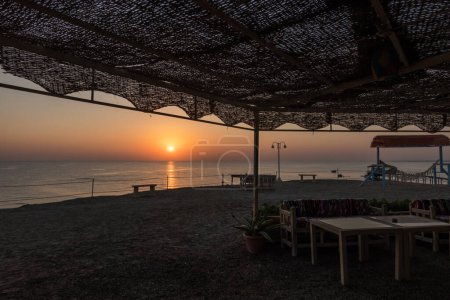 warm sunrise at the sea view from the beach club on vacation in egypt