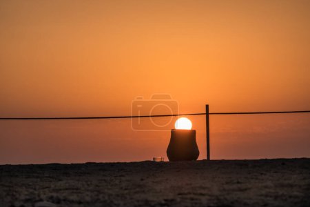 white glowing sun in a amphora at the beach during sunrise in egypt