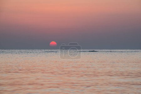 wonderful warm red sun over the horzizon at the sea in egypt