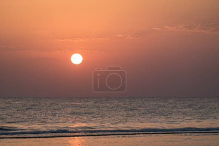 warm bright white sun with little clouds during sunrise in egypt
