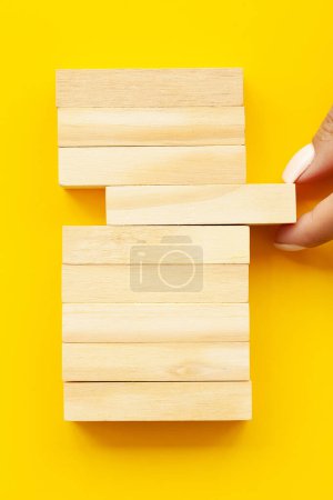 Woman hand stacked wooden blocks with space for text.