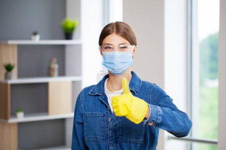 Photo for A young female professional cleaner cleans a modern office. - Royalty Free Image