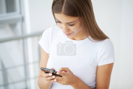 Photo for Lazy woman relax in the office hold smart phone use apps. - Royalty Free Image