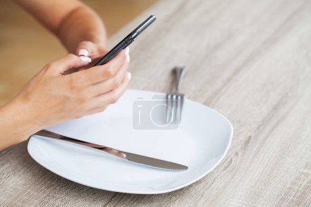 Photo for Attractive woman looking at smartphone screen, reading media news. - Royalty Free Image