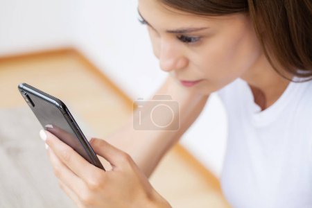 Photo for Woman holding smart phone chatting in social media. - Royalty Free Image