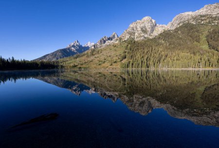 a scenic reflection landscape at String Lake in Grand Teton National Park Wyoming in autumn