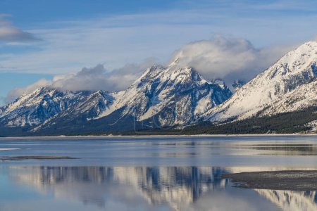 Photo for A scenic landscape reflection of the Tetons in Jackson Lake in spring - Royalty Free Image