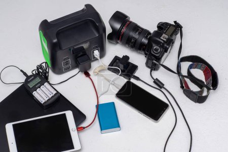 Photo for Charging station for phone, tablet, laptop and camera. No light during blackout. Generator power bank battery. Charge electric rechargeable. Ukraine, Kyiv - December 8, 2022 - Royalty Free Image