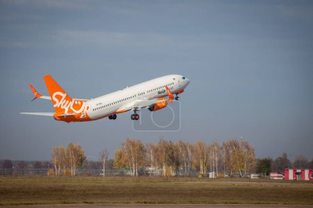 Photo for Kyiv, Ukraine - November 14, 2019: The orange plane flies in the sky. SkyUP Ukrainian Airlines passenger plane takes off at the Boryspil airport. UR-SQA SkyUp Airlines Boeing 737-800 - Royalty Free Image