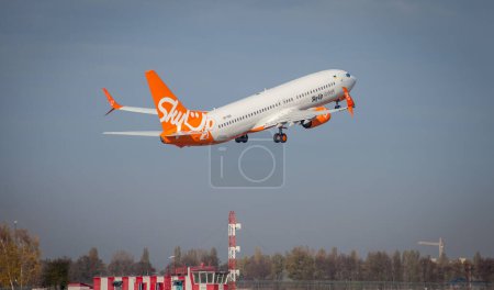 Photo for Kyiv, Ukraine - November 14, 2019: The orange plane flies in the sky. SkyUP Ukrainian Airlines passenger plane takes off at the Boryspil airport. UR-SQA SkyUp Airlines Boeing 737-800 - Royalty Free Image