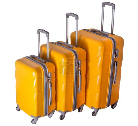 Foto de Un juego de maletas amarillas sobre ruedas. Equipaje. Maleta de viaje aislada sobre fondo blanco. - Imagen libre de derechos