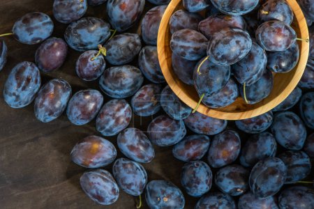 Variété de prunes hongroise. Récolte de fruits sur la table dans la cuisine. Prune bleue d'automne. Bol alimentaire vitaminé.