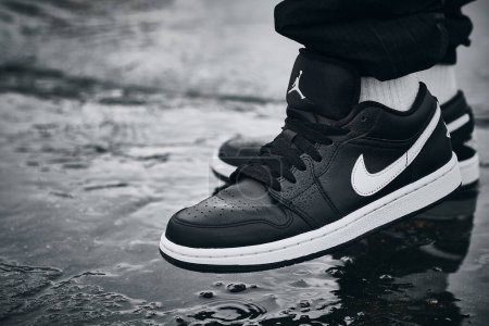 Foto de On-feet Nike Air Jordan I Black White on wet surface illustrative editorial - Imagen libre de derechos