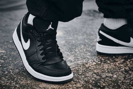 Photo for On-feet Nike Air Jordan I Black White on wet surface illustrative editorial - Royalty Free Image