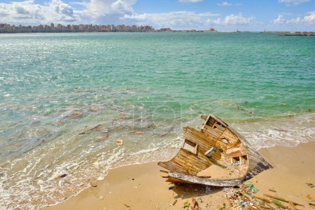 Photo for Wooden remains of boat and rubbish lie on sand. Wreckage of a sea vessel on a beach - Royalty Free Image